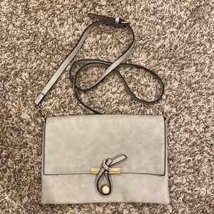 Gray Cross body- Never used no name bag from Francesca’s magnet enclosure